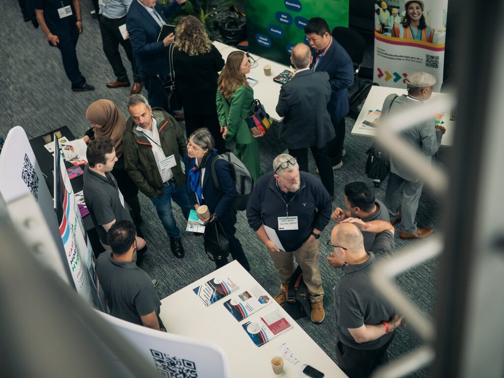 People chat on the exhibition floor at the 2024 Hydrogen Summit.