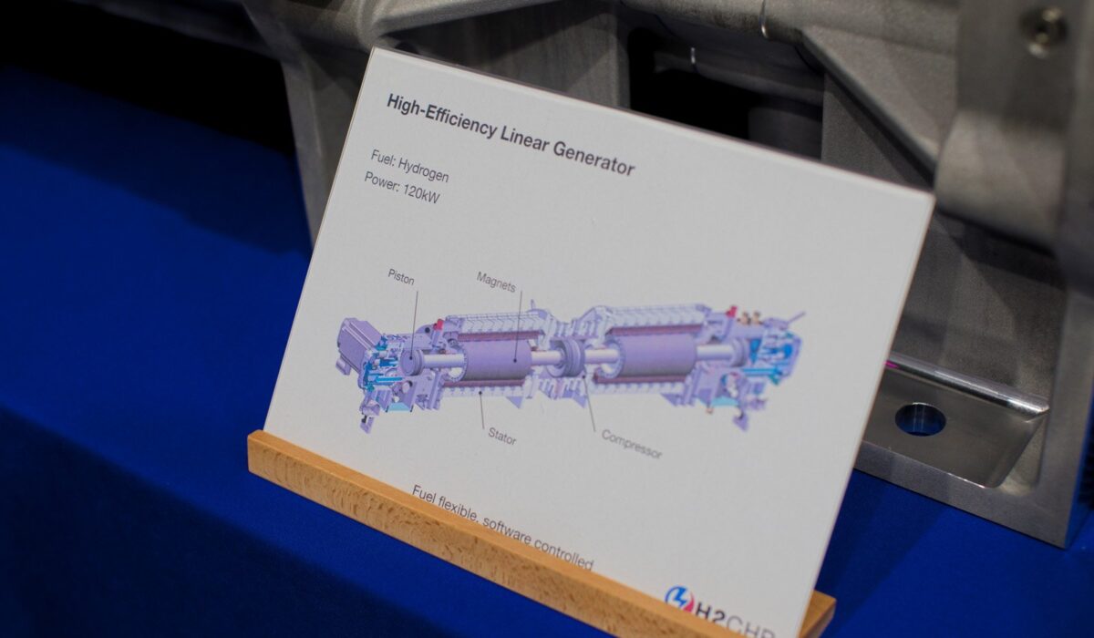 Hydrogen Summit 2025 154 A close-up of an informational sign on an exhibit table for a "High-Efficiency Linear Generator." The sign includes a diagram showing the Piston, Magnets, Stator, and Compressor components, and lists the specifications: Fuel: Hydrogen, Power: 120kW.
